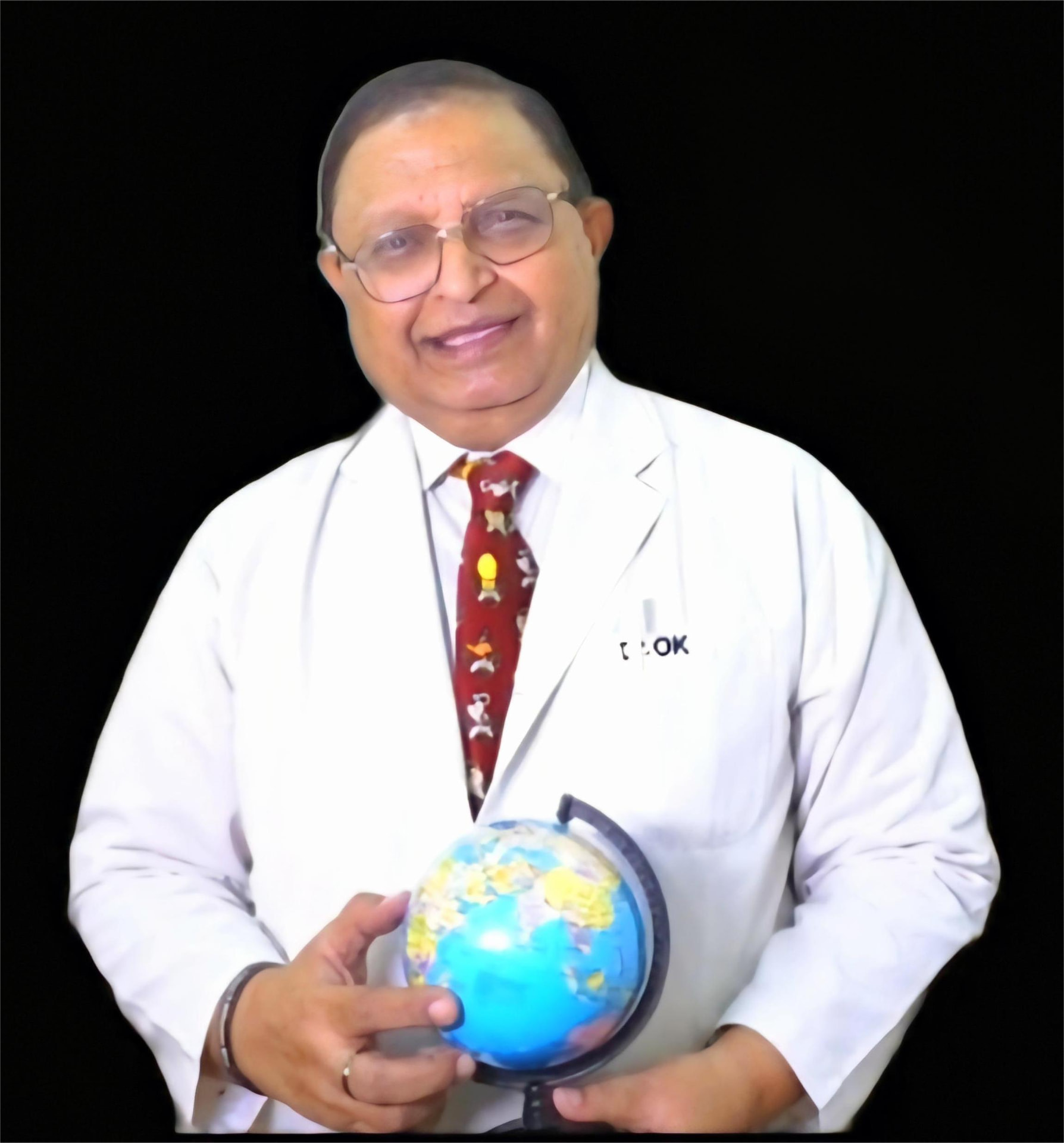 Dr. Omesh Khurana, senior paediatrician, holding a globe